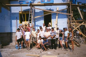 Participants in the Summer Youth Build pose for a group shot with local volunteers and homeowners. The Cluj site is also a site for the World Leaders Build. (World Leaders Build 2001)
