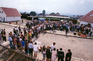 Volunteers and homeowners gather to dedicate 10 Habitat houses at the close of the Romania Eclipse Build 1999.
