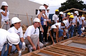 Participants in the Warner Brothers Build prepare to lift a wall frame. (2000)