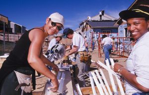 Volunteers Rita Smith of DeSoto, Texas, and Tracy Young of Denver, Colorado, help with house building. (Women Building a Legacy 2001)