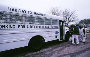 Offenders from the Fabian Dale Dominguez State Jail in San Antonio, Texas, board the bus given to the jail by Habitat for Humanity to transport offenders to and from Habitat build sites. (Prison Partnership 2001)