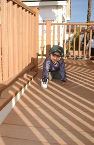Two-year-old Abraham Zavala plays on the porch of his family's new Habitat house at the dedication ceremony. (International Builders Show 2003)