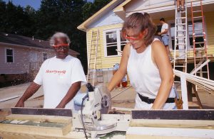 A Habitat homeowner and volunteer work together on the construction of a house. (Atlanta Olympic Build 2001)
