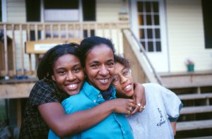 Cindy Johnson is pictured with her daughters Crystal and Christy in front of their Habitat house that was completed during the Jimmy Carter Work Project 1997. (JCWP Revisited, 1998)