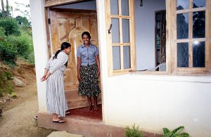 A woman receives a visitor to her Habitat house in Sri Lanka. (2000)