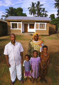Homeowner Fatuma Jabili and his family are pictured in front of their Habitat house in Ifakara, Tanzania. (2002)