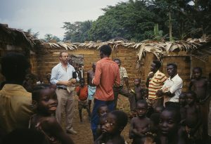 Clive Rainey speaks to a group of men in Zaire. (1987)