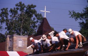 Volunteers work on the roof of a Habitat house. (50,000th House, 1996)